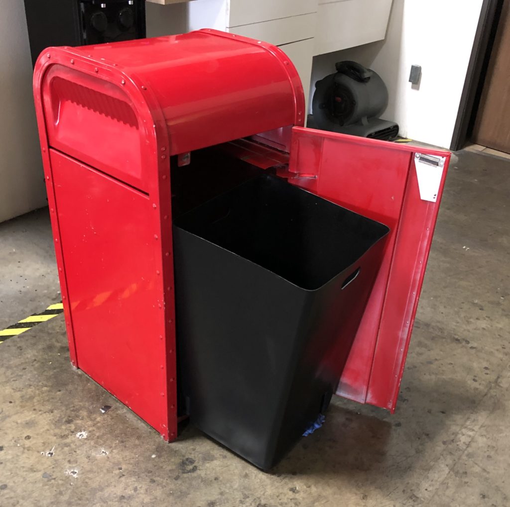 black square trash liner in red trash can